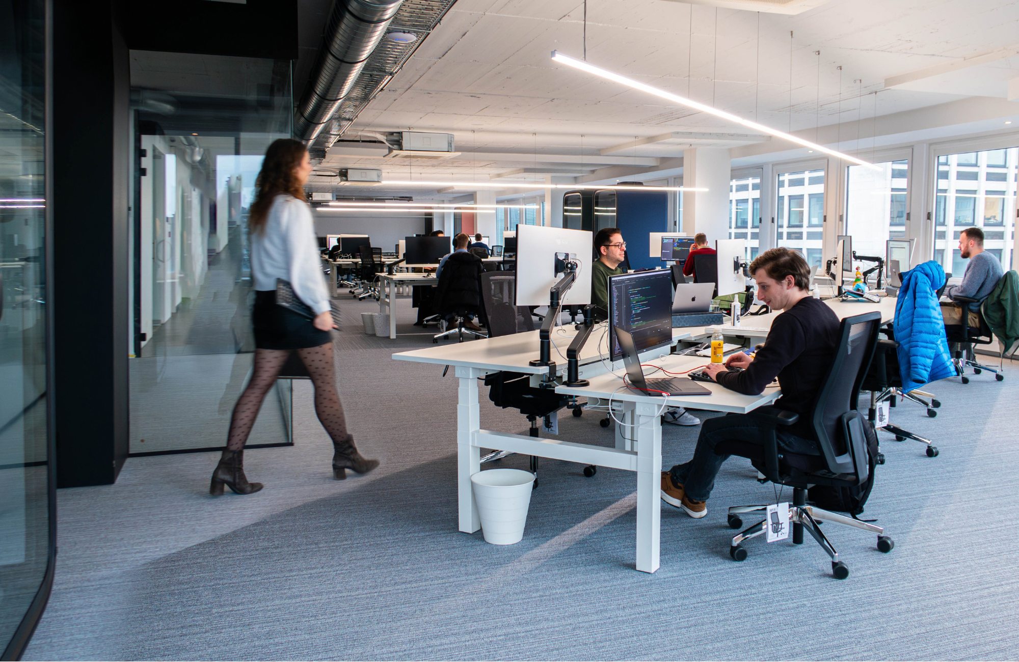 Modern team working in an office environment, representing a future-focused and evolving way of working