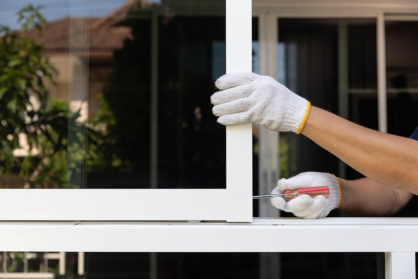 Person installing a window Person installing a window