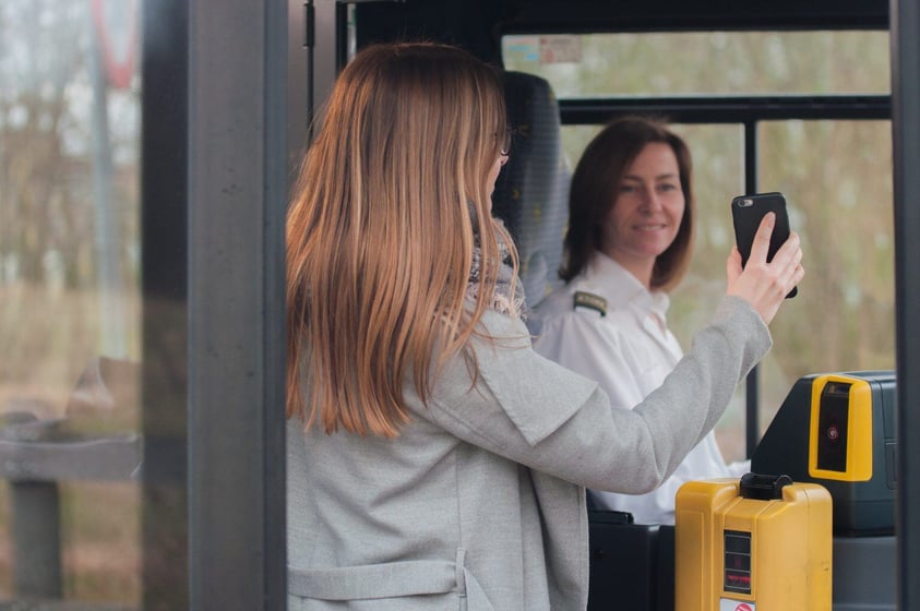 woman getting on bus woman getting on bus