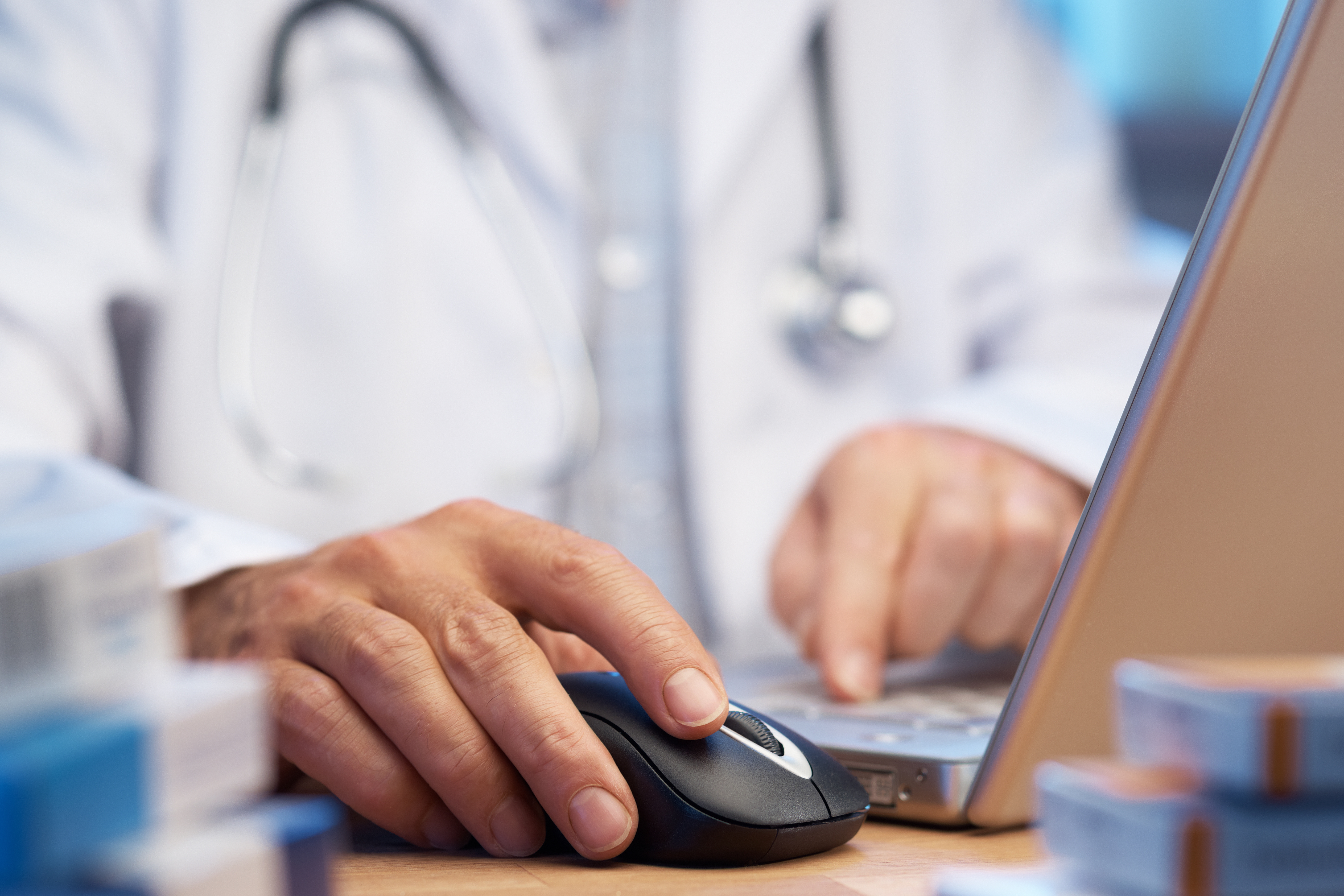A doctor using a laptop