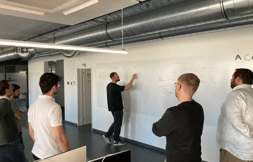 Trainer guiding a group during a hands-on session focused on role-based product training