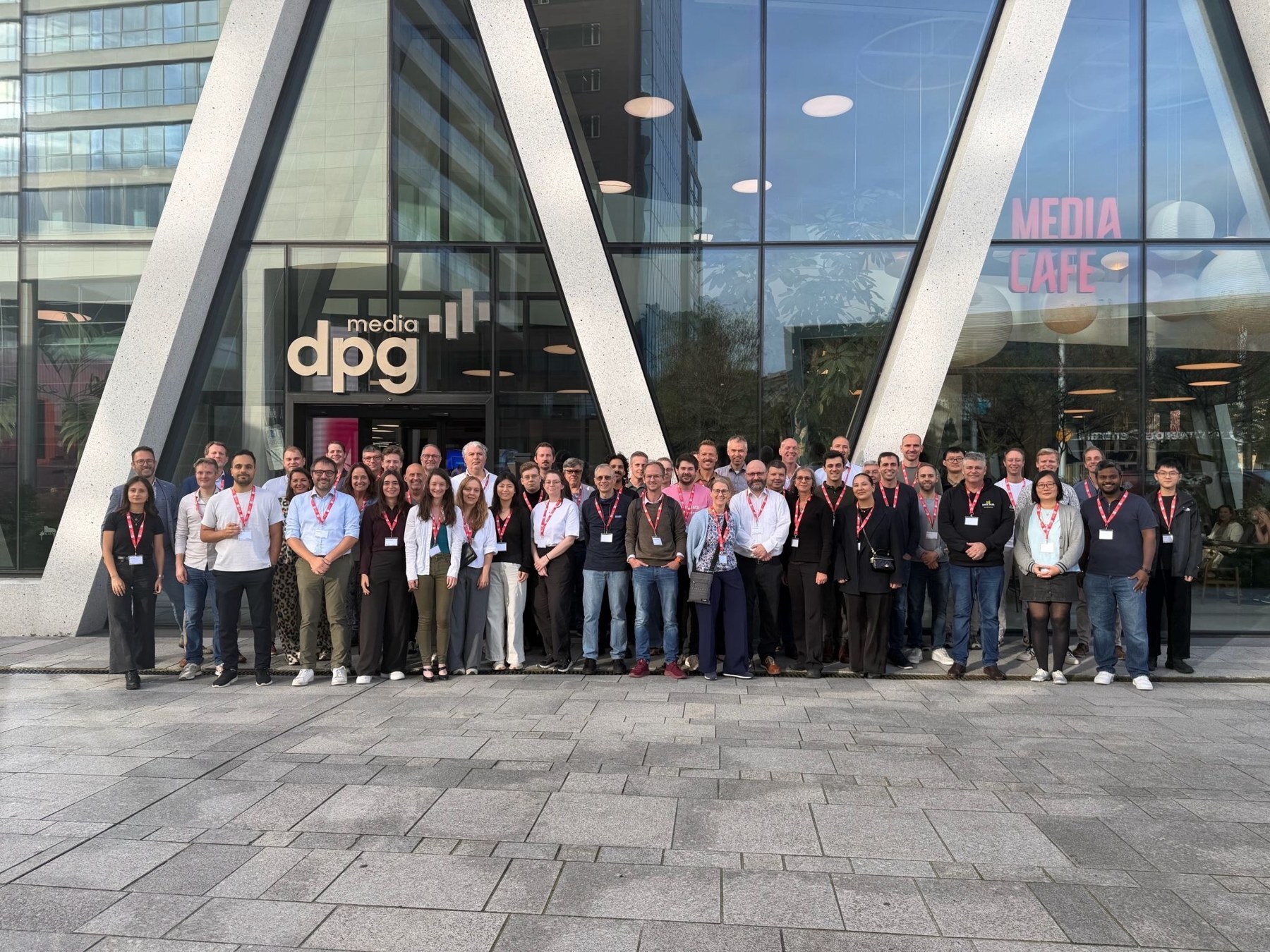 Speakers and attendees of the POA Summit 2026 in front of DPG Media in Antwerp