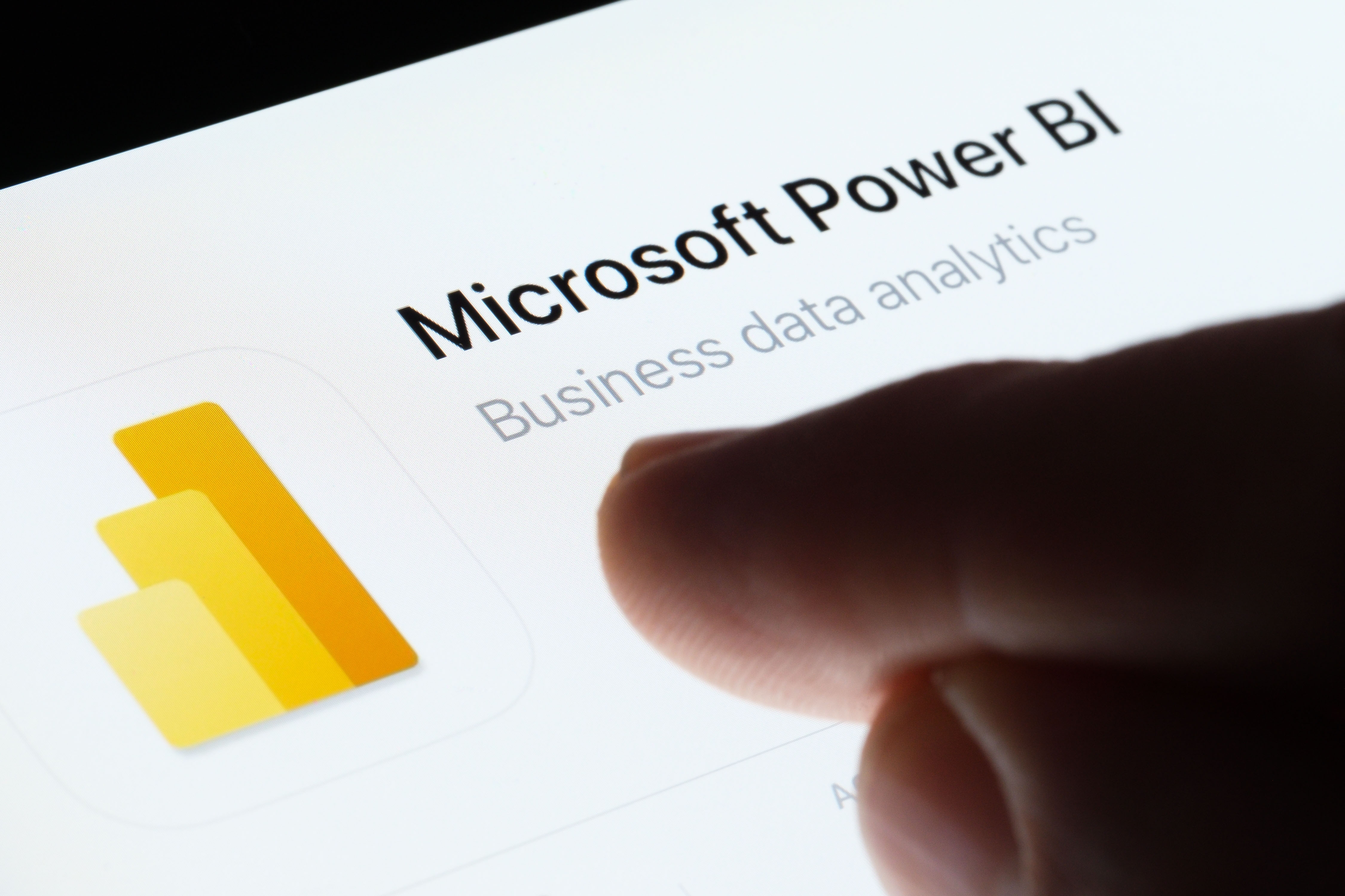 Image of a person pointing at the Power BI app